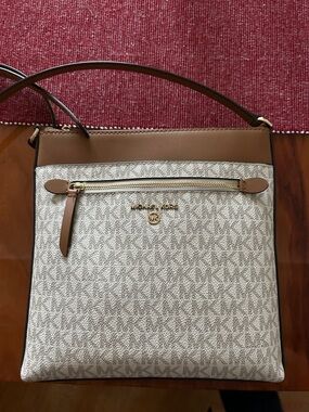 Zipper charm is missing and there are some ink stains from a pen (pictured)